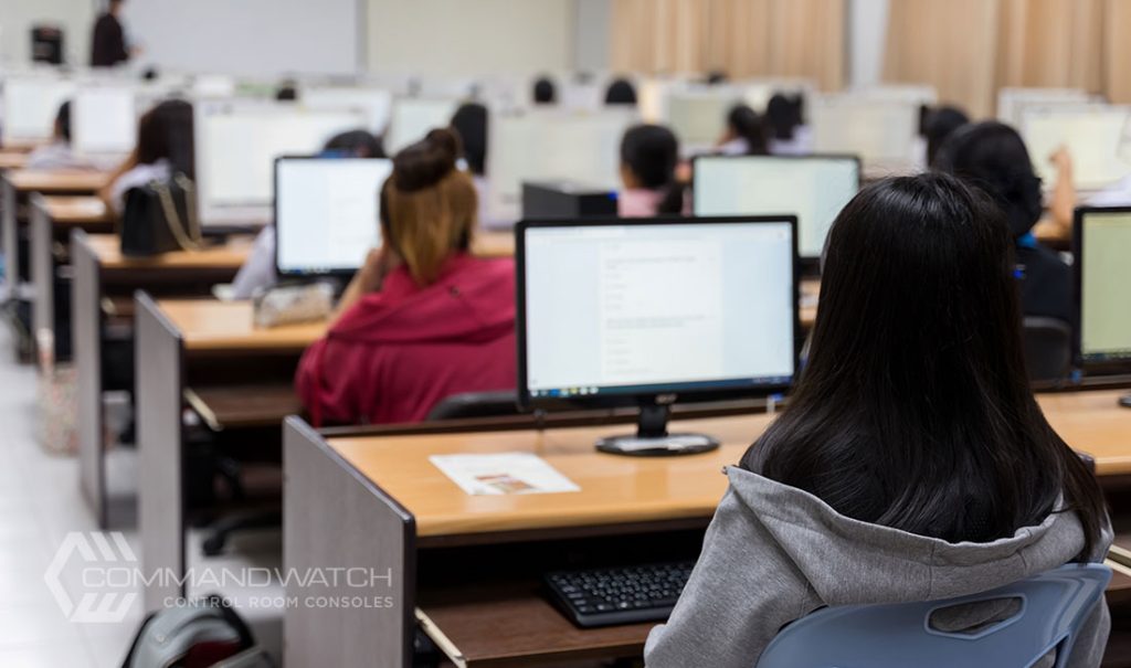 control room furniture setup in a university computer science lab, with students seated at workstations