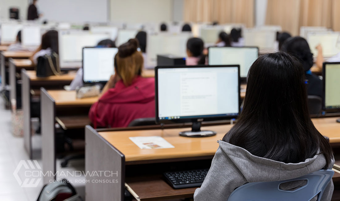 control room furniture setup in a university computer science lab, with students seated at workstations